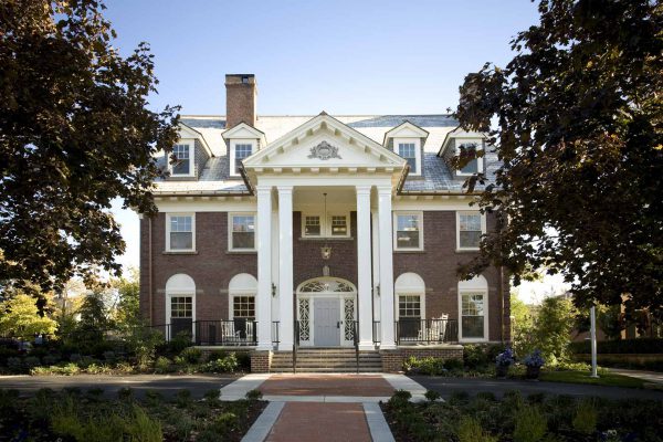 Main entrance flanked by two-story Greek-influenced columns and pediment