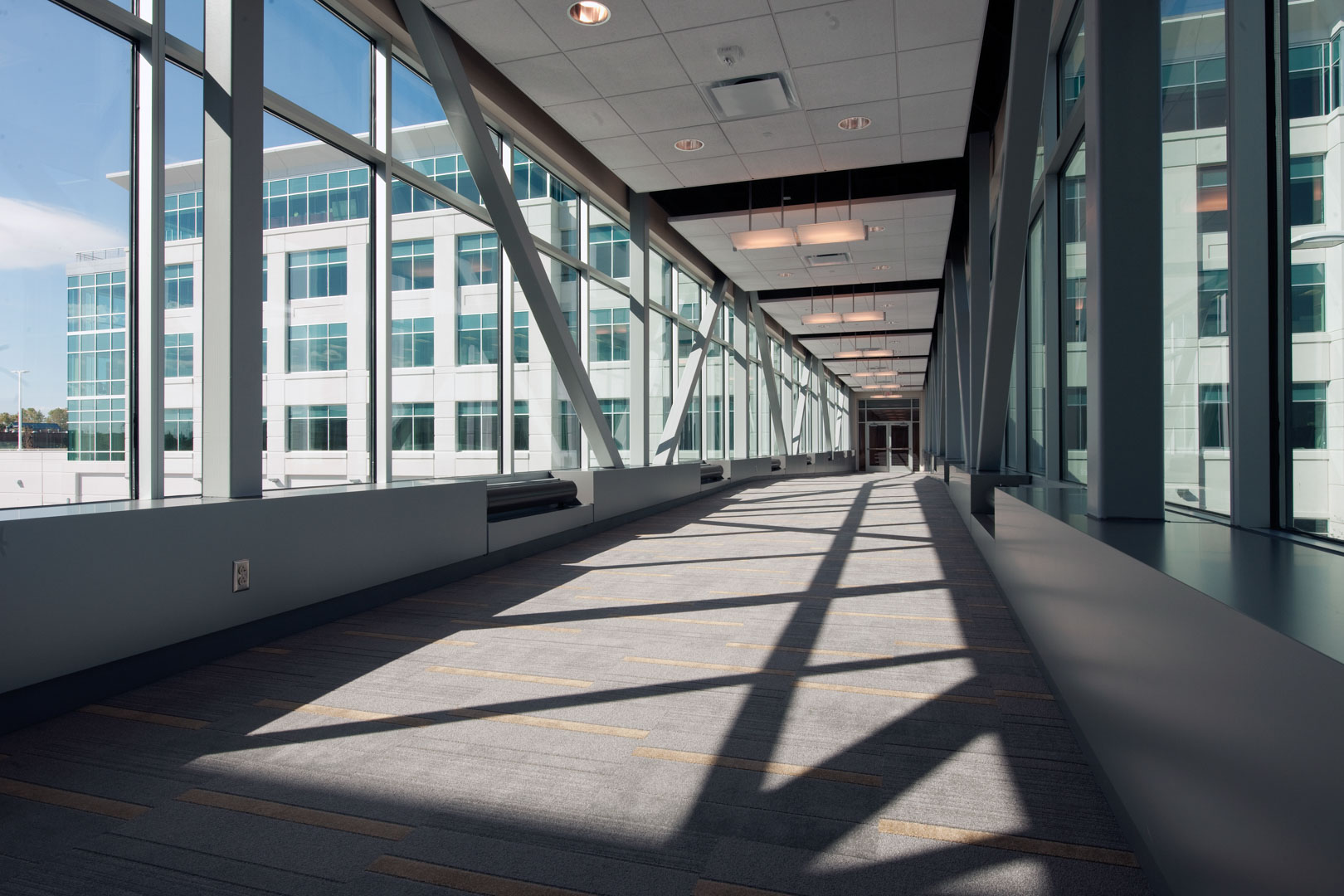 A pedestrian bridge connects the new office building to the existing buildings