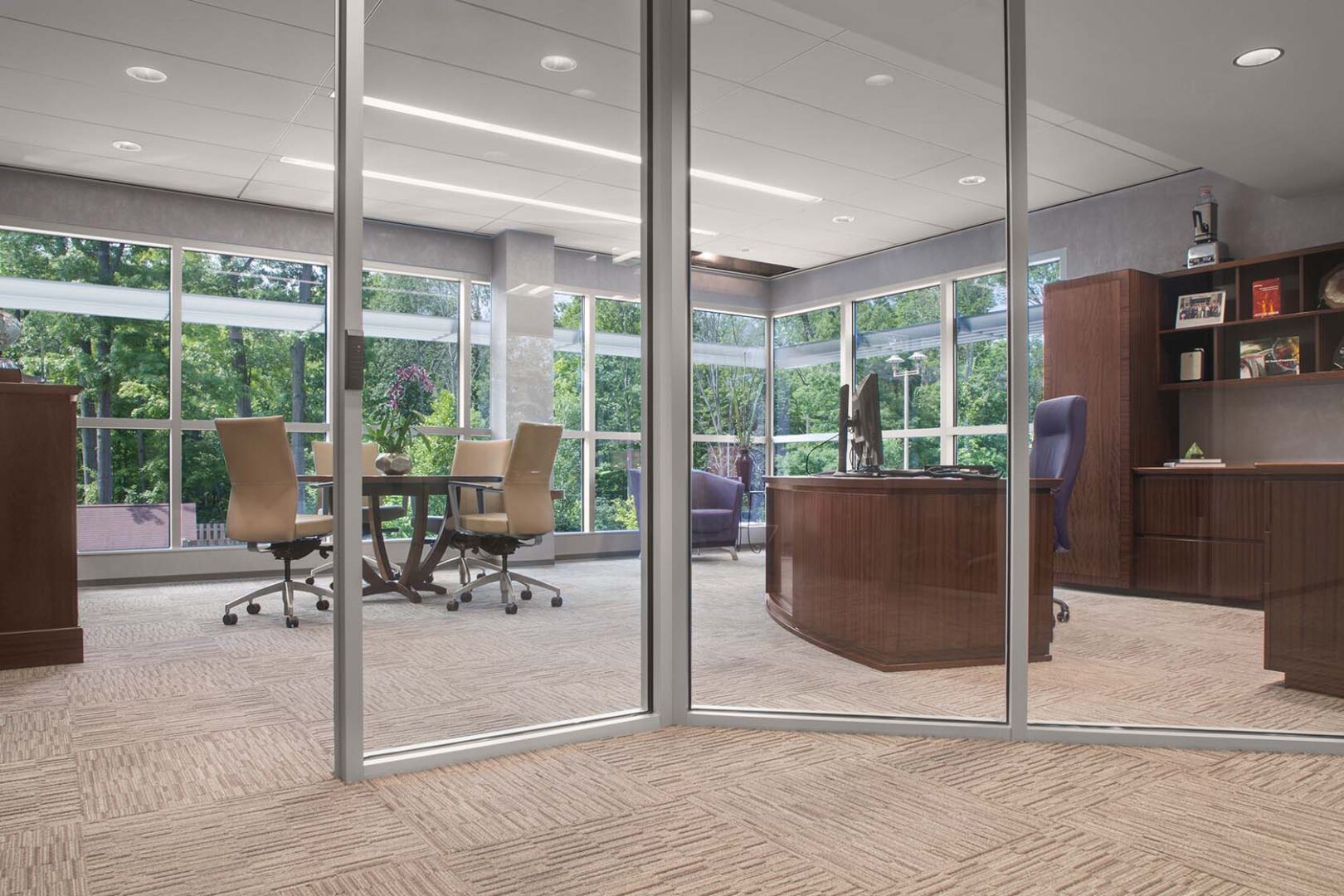 An office with glass walls and a window