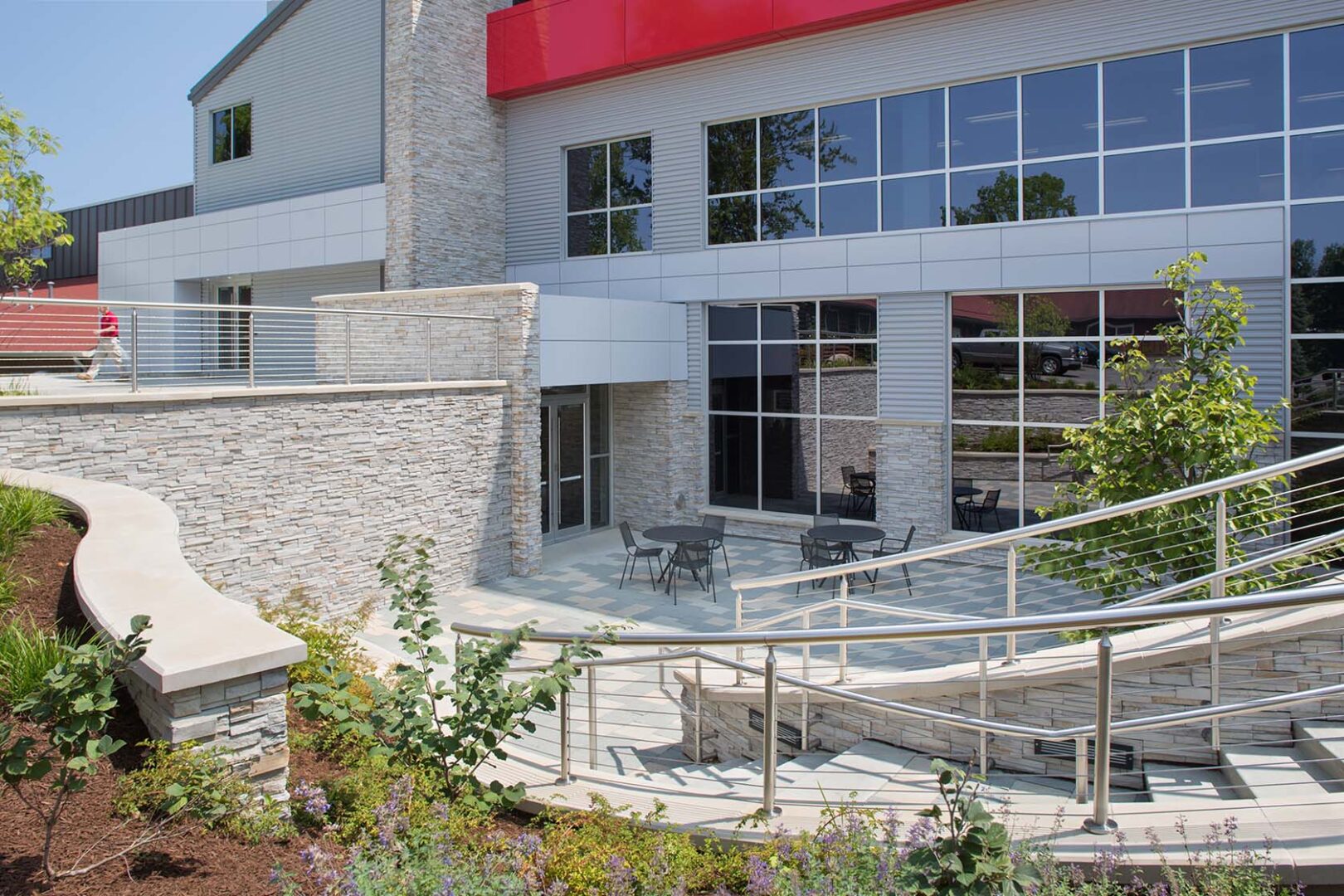 Exterior with a patio and a cafe tables in front