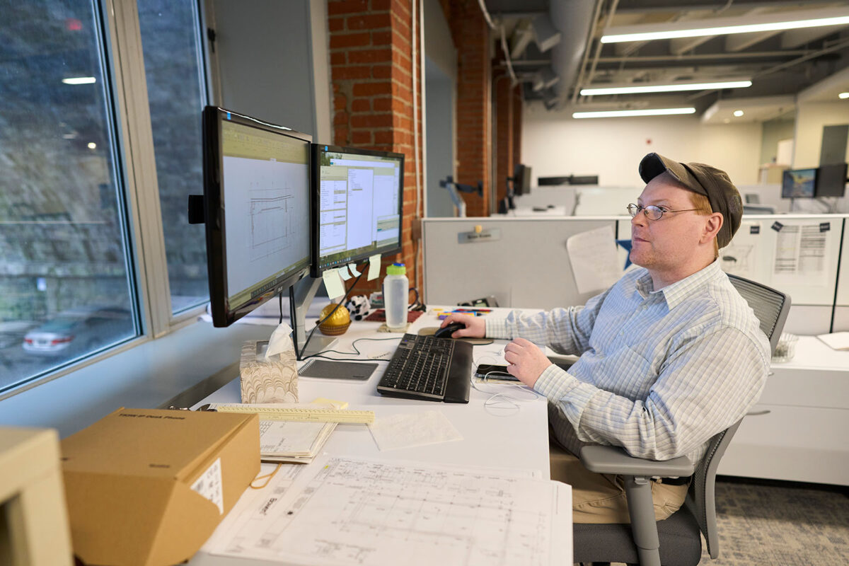 man at desk with computer