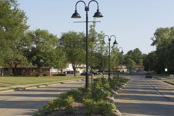 A daytime image of suburban street in North Olmsted Ohio with a median containing streetlights in the middle. From Bowen Municipal Engineering