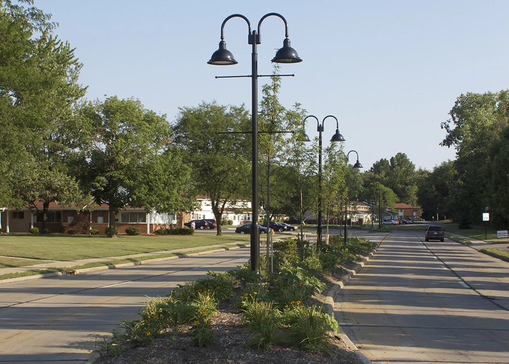 A daytime image of suburban street in North Olmsted Ohio with a median containing streetlights in the middle. From Bowen Municipal Engineering